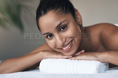 Buy stock photo Portrait of a young woman lying on a massage bed at a spa
