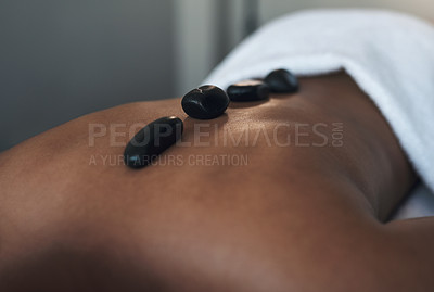 Buy stock photo Closeups shot of an unrecognisable man getting a hot stone massage at a spa
