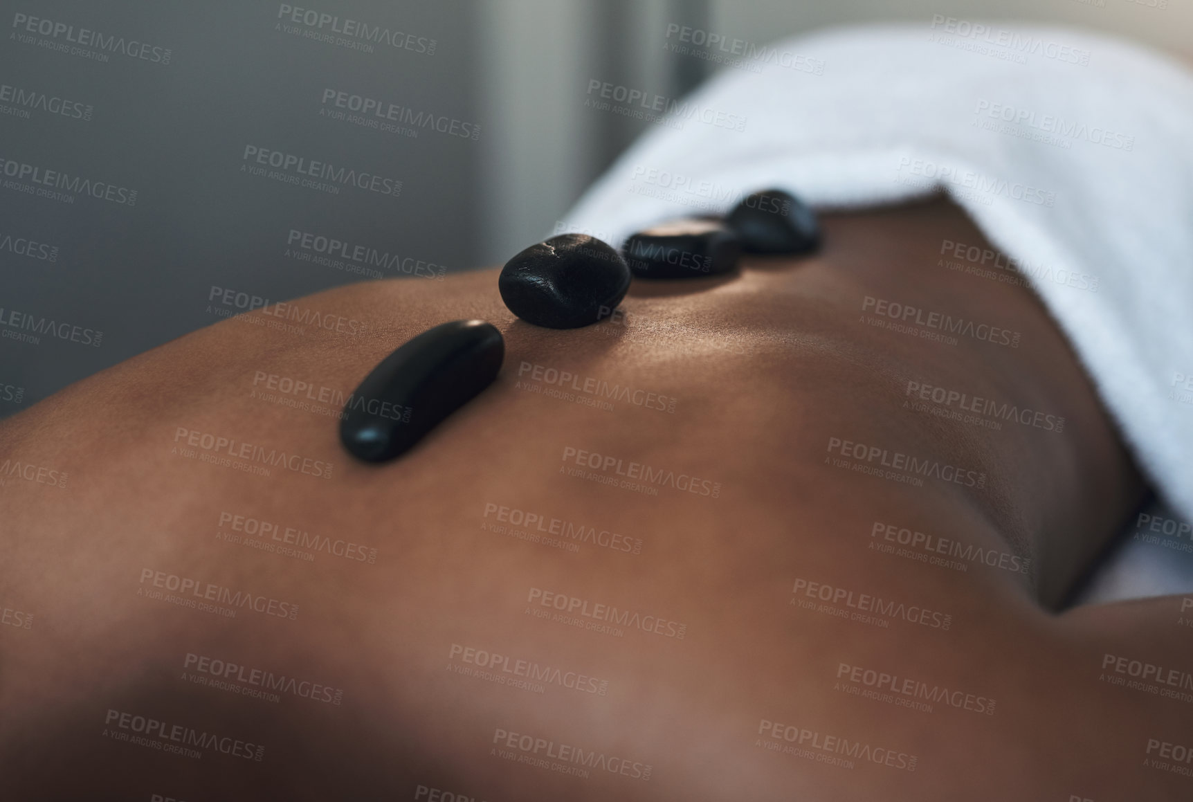 Buy stock photo Closeups shot of an unrecognisable man getting a hot stone massage at a spa