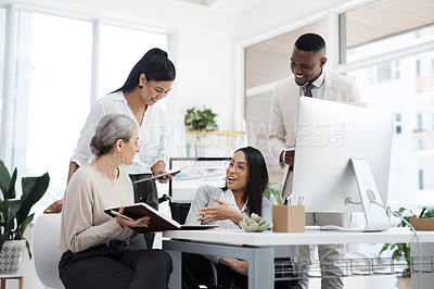 Buy stock photo Cropped shot of a group of diverse businesspeople having an informal meeting in their office
