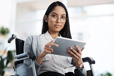 Buy stock photo Cropped portrait of an attractive young businesswoman in a wheelchair using her tablet in the office