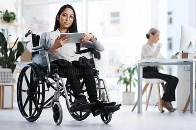 Buy stock photo Full length portrait of an attractive young businesswoman in a wheelchair using her tablet in the office