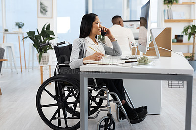 Buy stock photo Full length shot of an attractive young businesswoman in a wheelchair making a phonecall while working at her desk in the office