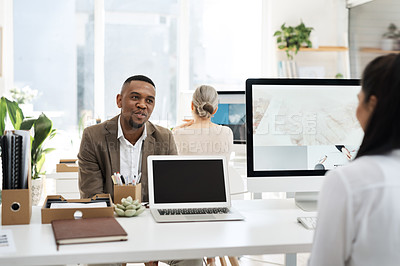 Buy stock photo Cropped shot of a handsome young businessman meeting with a female colleague in the office