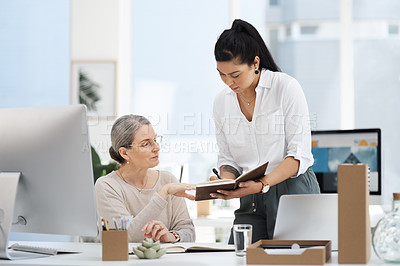 Buy stock photo Cropped shot of an attractive young businesswoman getting some information from her human resources manager in the office