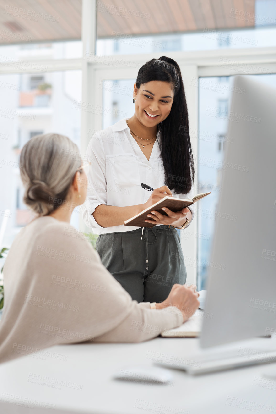 Buy stock photo Cropped shot of an attractive young businesswoman getting some information from her human resources manager in the office