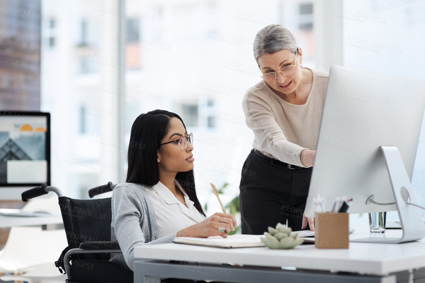 Buy stock photo Cropped shot of an attractive young businesswoman getting some information from her human resources manager in the office