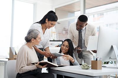 Buy stock photo Cropped shot of a group of diverse businesspeople having an informal meeting in their office