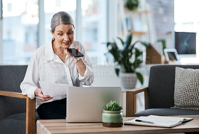 Buy stock photo Shot of a mature businesswoman talking on a cellphone while going through paperwork in an office