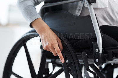 Buy stock photo Cropped shot of an unrecognizable businesswoman sitting in a wheelchair in the office