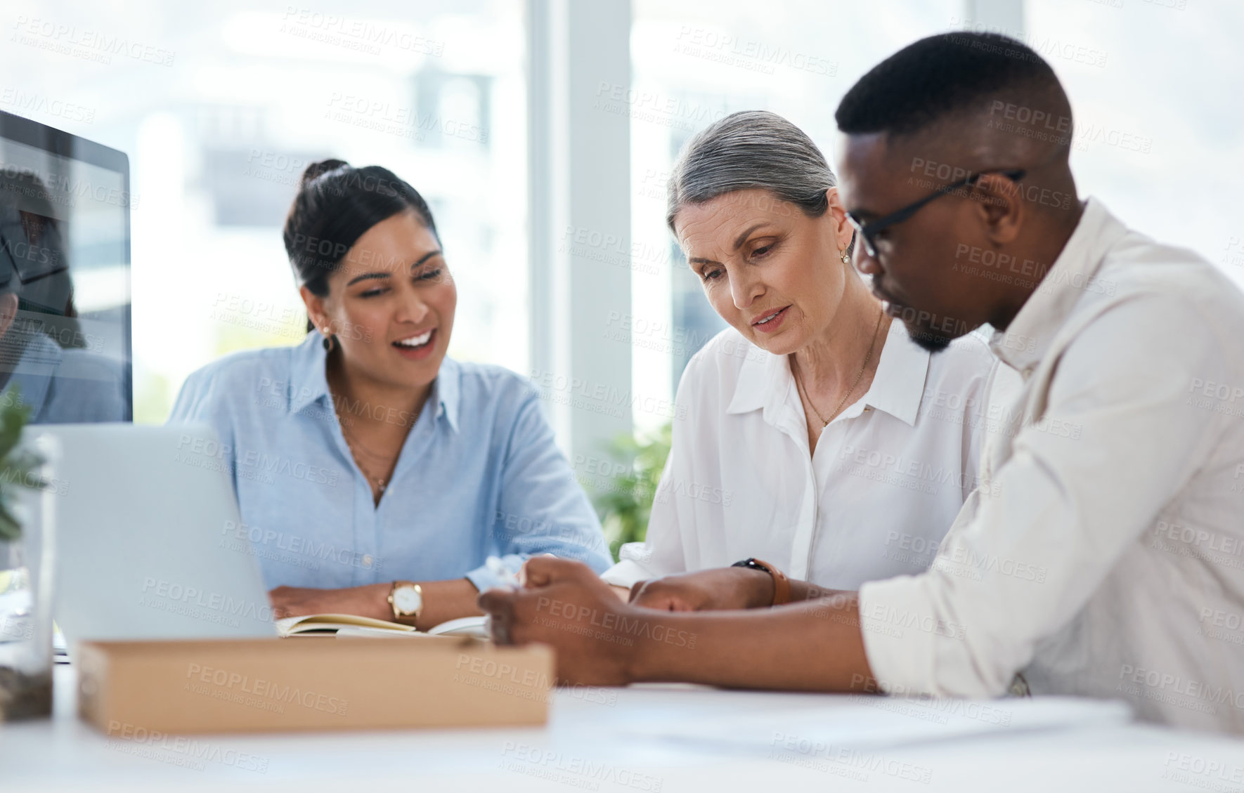 Buy stock photo Shot of a group of businesspeople working together in an office