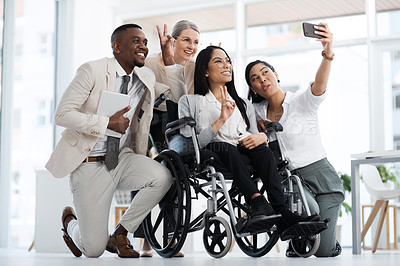 Buy stock photo Full length shot of a group of diverse businesspeople taking selfies while gathered in their office