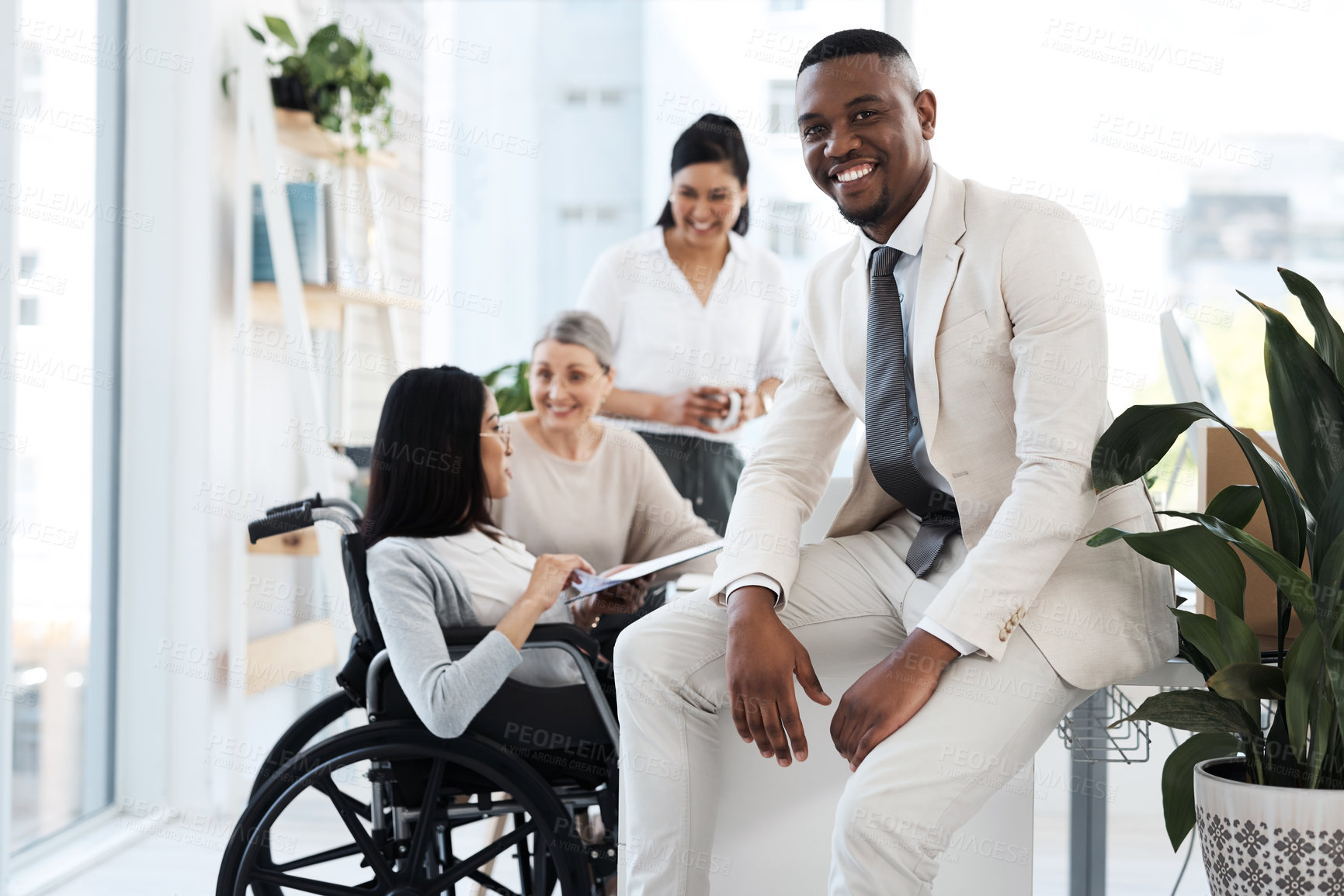 Buy stock photo Cropped portrait of a handsome young businessman in the office with his colleagues meeting in the background