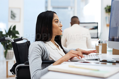 Buy stock photo Cropped shot of an attractive young businesswoman working on a computer at her desk in the office