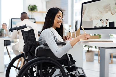 Buy stock photo Cropped shot of an attractive young businesswoman in a wheelchair writing in her notebook while working in the office