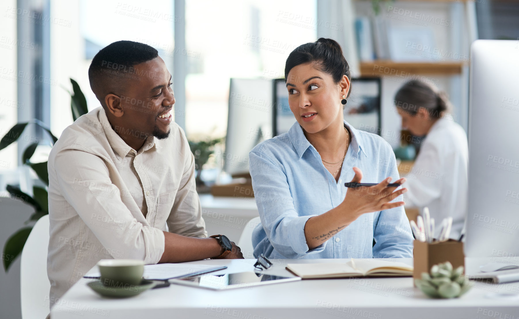Buy stock photo Shot of two businesspeople working together on a computer in an office