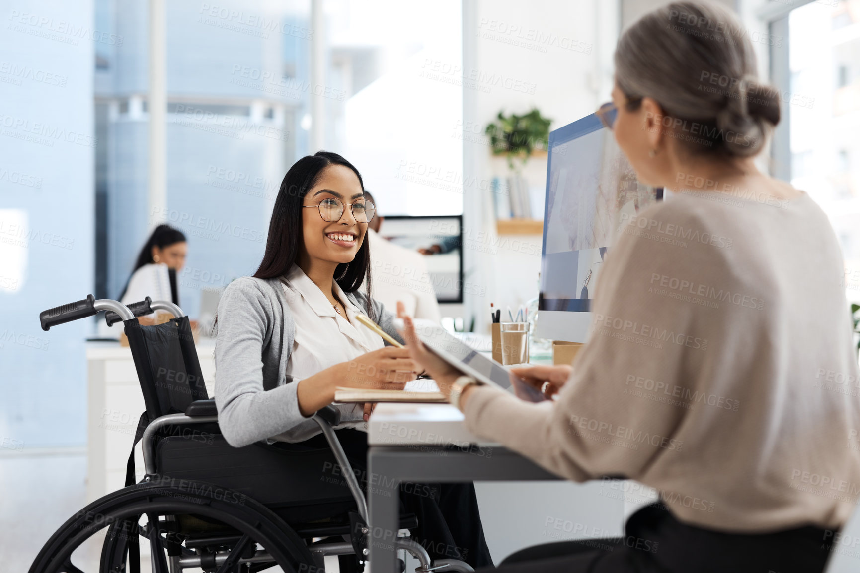 Buy stock photo Cropped shot of an attractive young businesswoman getting some information from her human resources manager in the office