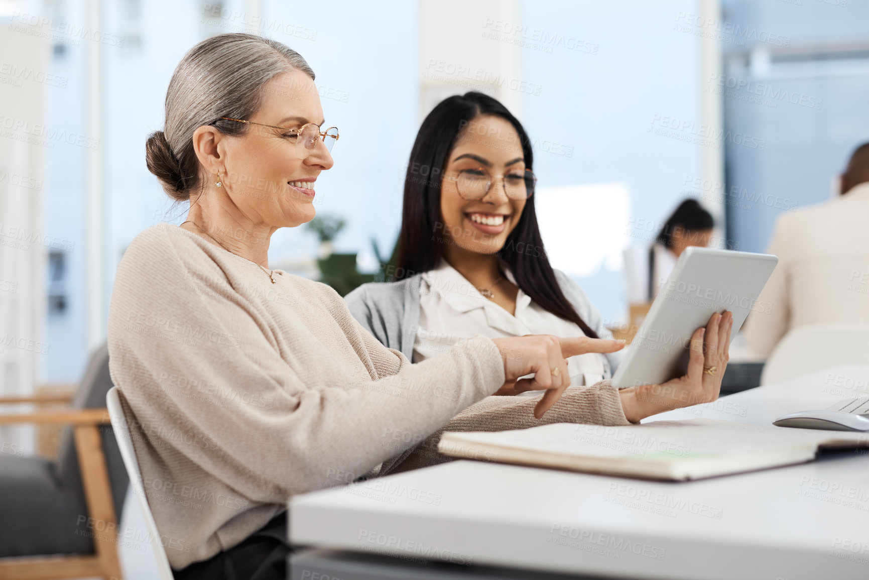 Buy stock photo Cropped shot of an attractive young businesswoman getting some information from her human resources manager in the office