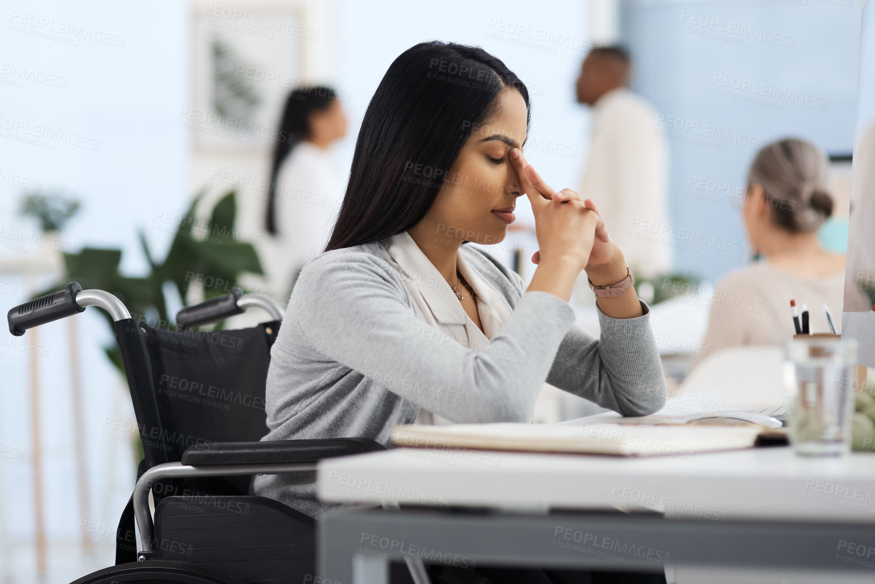 Buy stock photo Cropped shot of an attractive young businesswoman looking stressed while working at her desk in the office