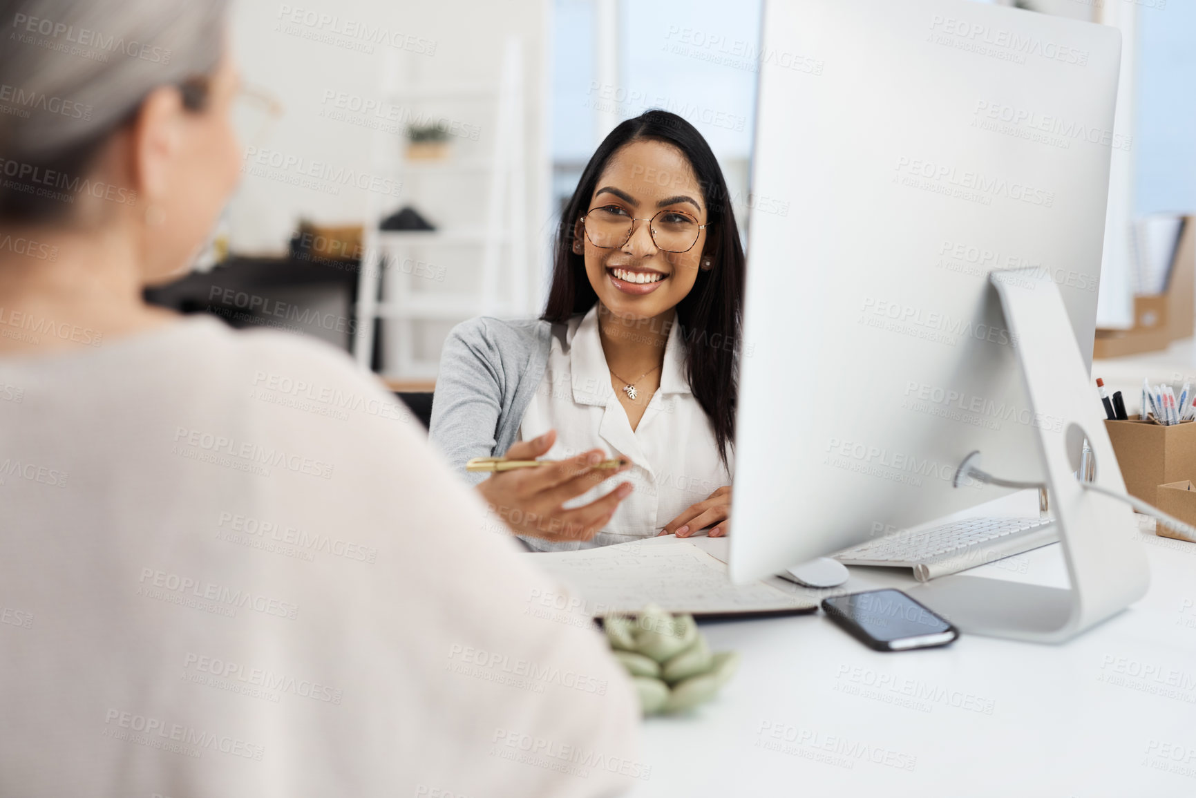 Buy stock photo Cropped shot of an attractive young businesswoman getting some information from her human resources manager in the office