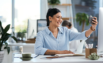 Buy stock photo Shot of a young businesswoman taking selfies in an office