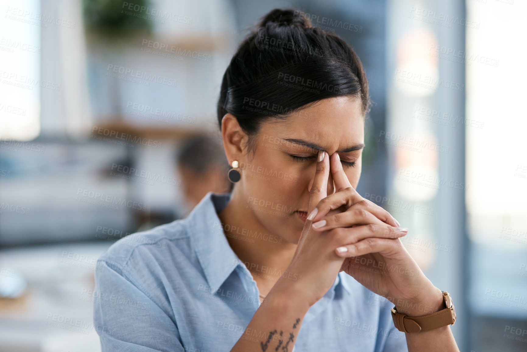 Buy stock photo Shot of a young businesswoman looking stressed out while working in an office