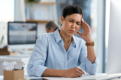 Buy stock photo Shot of a young businesswoman looking stressed out while working in an office