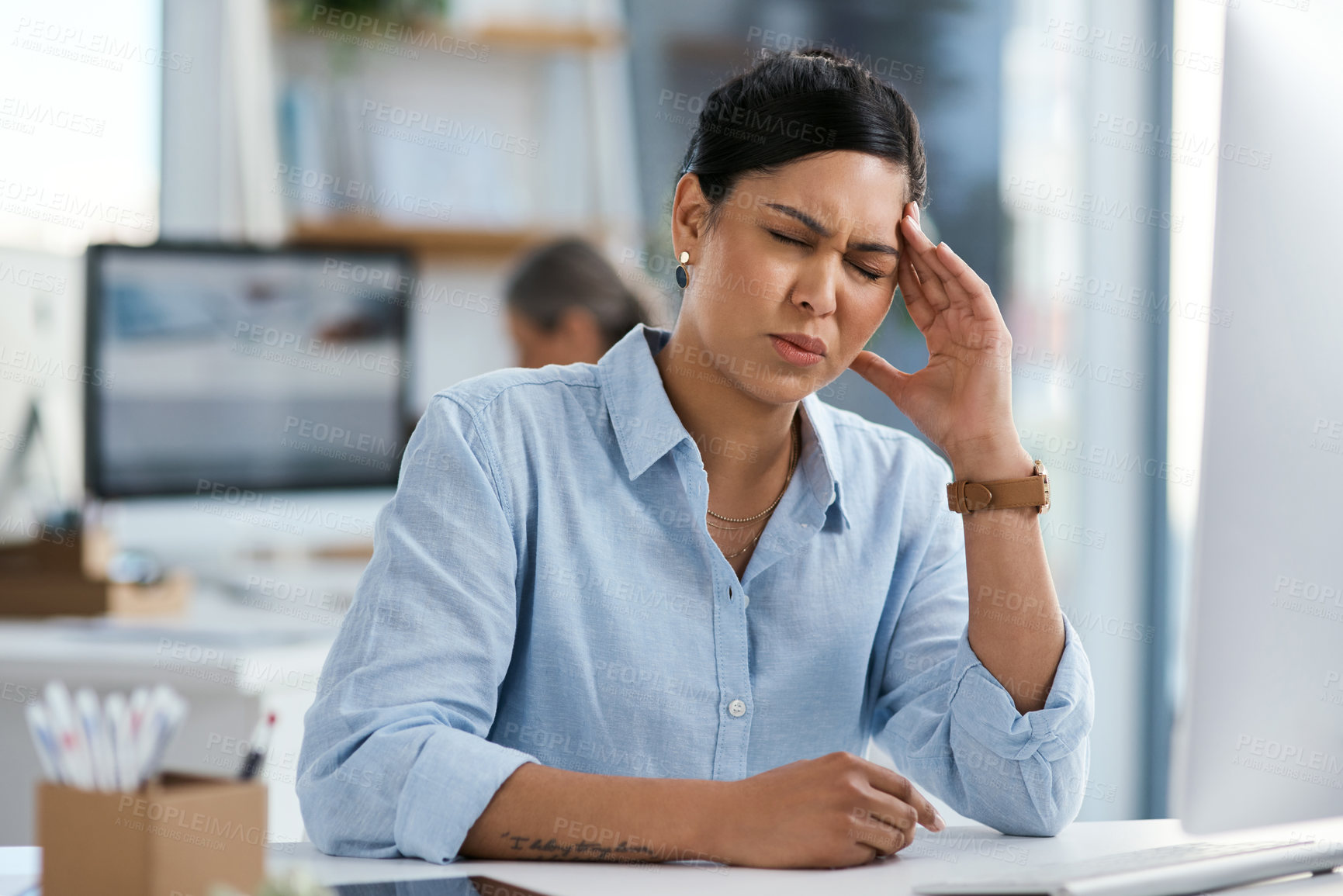 Buy stock photo Shot of a young businesswoman looking stressed out while working in an office