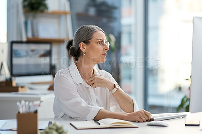 Buy stock photo Shot of a mature businesswoman looking thoughtful while working in an office