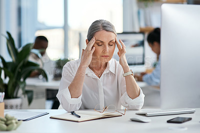 Buy stock photo Shot of a mature businesswoman looking stressed out while working in an office