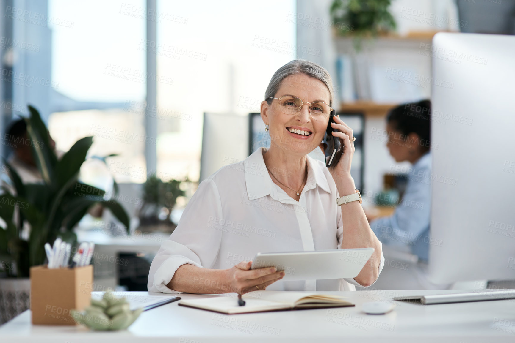 Buy stock photo Phone call, tablet and portrait of mature businesswoman in office with smile, contact and planning at digital agency. Woman, designer or consultant at tech startup with smartphone in coworking space