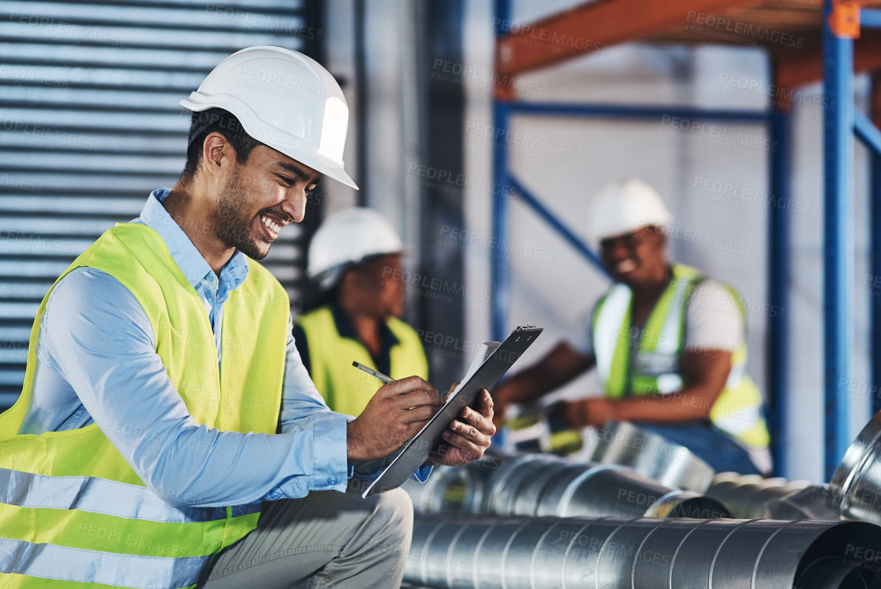 Buy stock photo Shot of a handsome young contractor crouching down and doing a stock-take in the warehouse