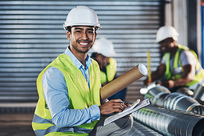 Buy stock photo Shot of a handsome young contractor crouching down and doing a stock-take in the warehouse