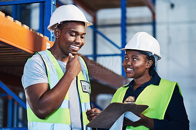 Buy stock photo Shot of two young contractors standing in the warehouse and having a discussion while doing a stock-take