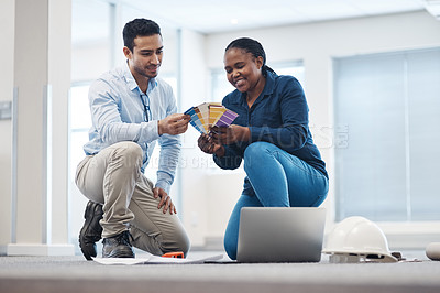 Buy stock photo Shot of a young architect talking to an interior designer colour swatches for the office