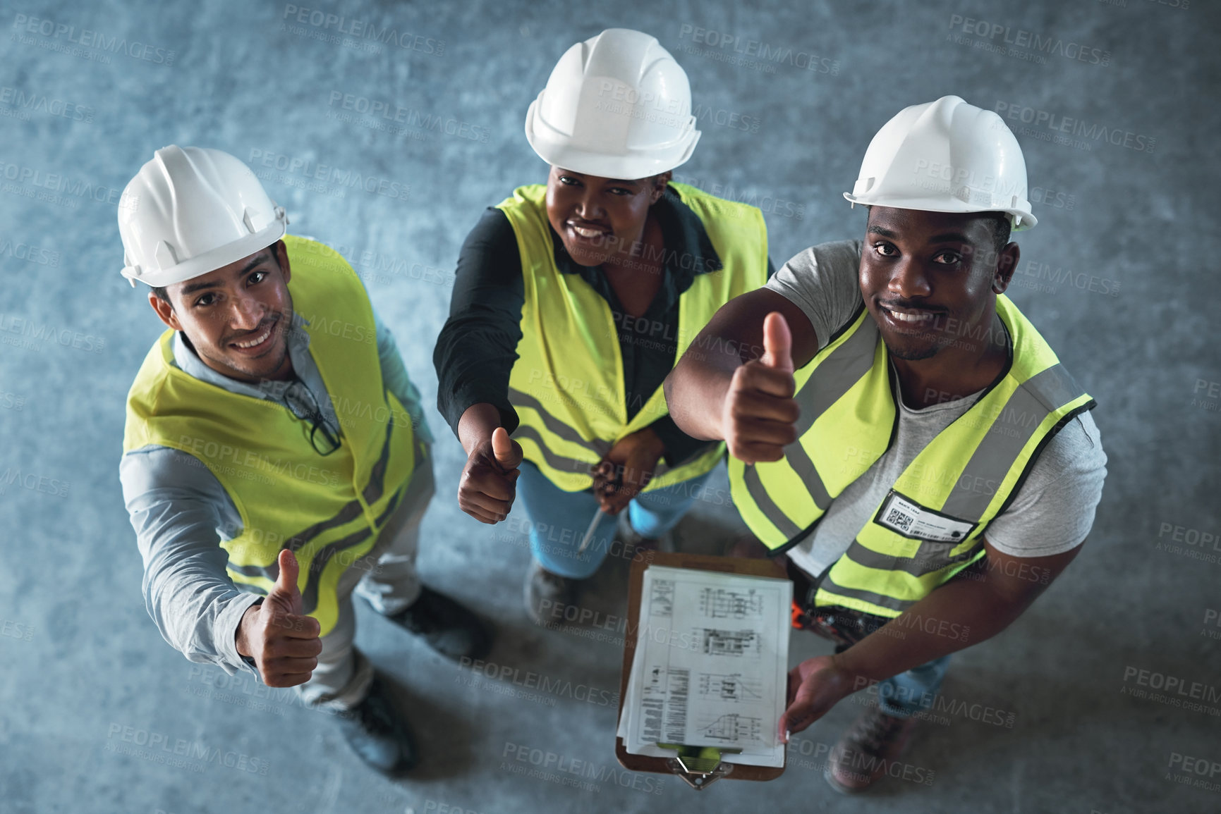 Buy stock photo High angle shot of a group of contractors standing in the warehouse together and making a thumbs up gesture