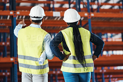 Buy stock photo Shot of two unrecognizable contractors standing together in the warehouse and observing the layout