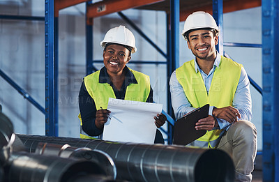 Buy stock photo Shot of two young contractors crouched down in the warehouse during a stock-take