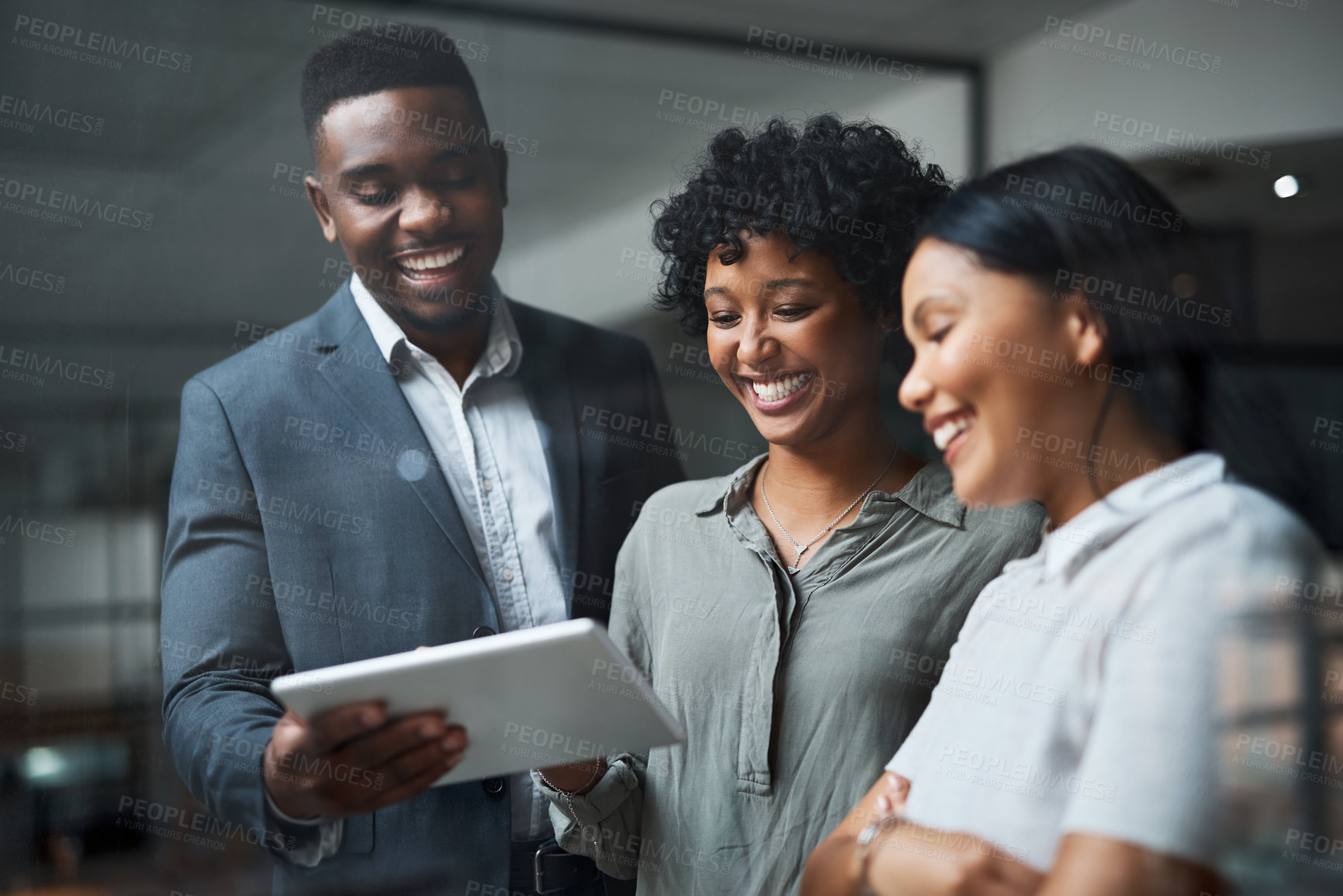 Buy stock photo Shot of three businesspeople working in a modern office