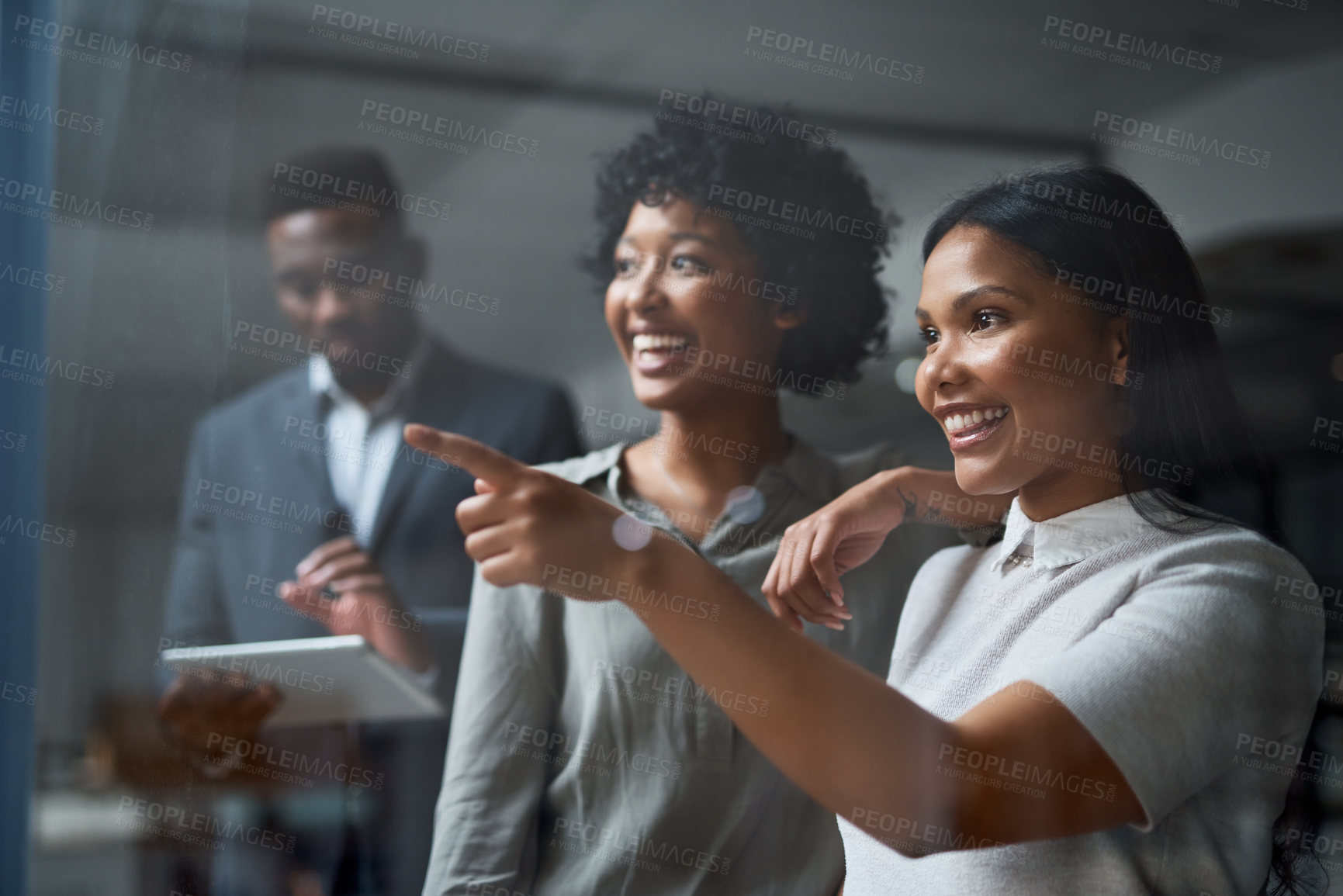 Buy stock photo Shot of three businesspeople working in a modern office