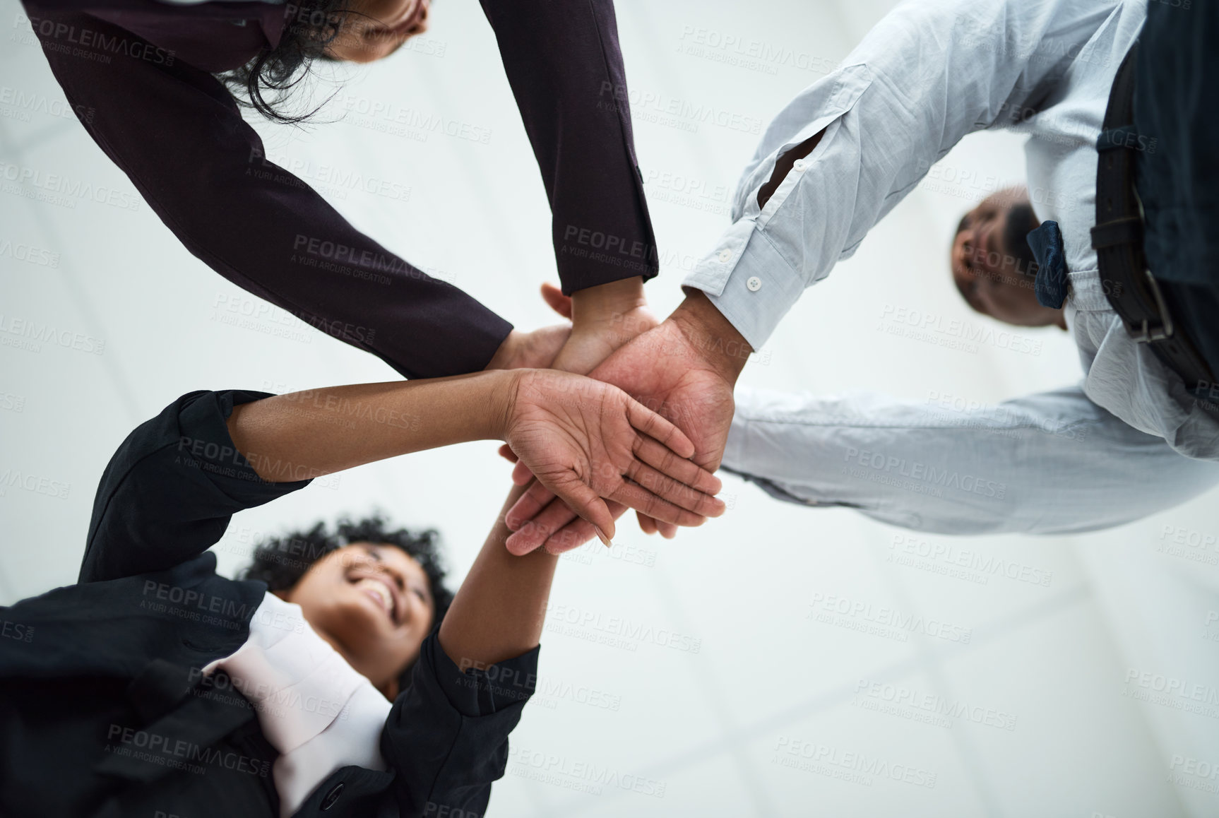 Buy stock photo Cropped shot of a group of unrecognizable businesspeople joining their hands together in a huddle