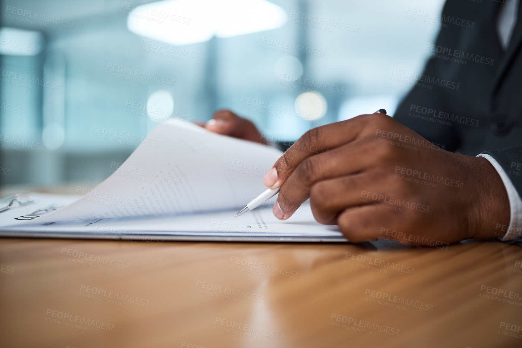 Buy stock photo Cropped shot of a businessman filling in paperwork in an office