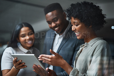 Buy stock photo Shot of three businesspeople working in a modern office