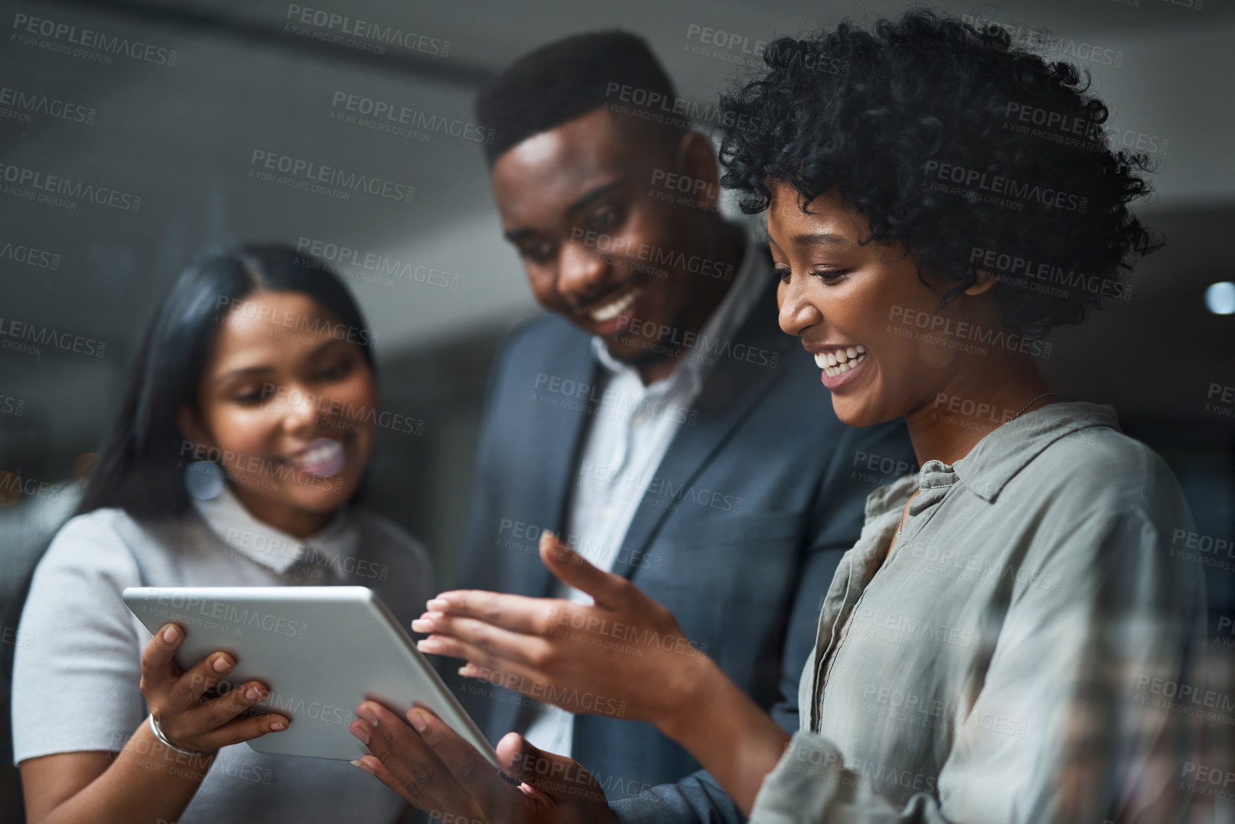 Buy stock photo Shot of three businesspeople working in a modern office