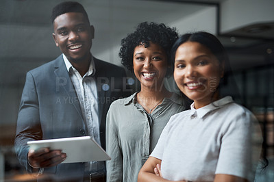 Buy stock photo Shot of three businesspeople working in a modern office