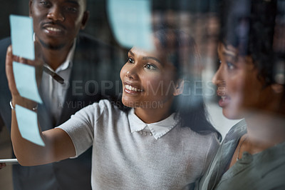 Buy stock photo Shot of three businesspeople working in a modern office