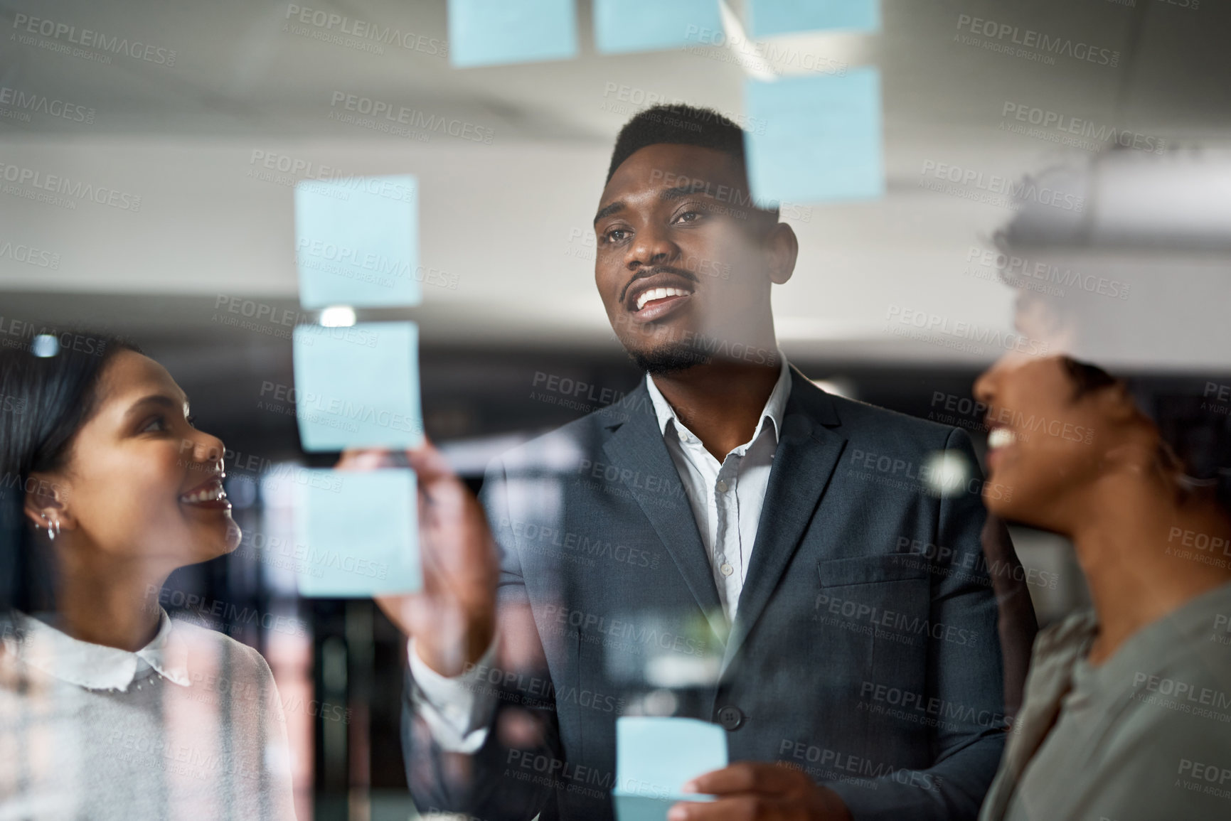 Buy stock photo Shot of three businesspeople working in a modern office