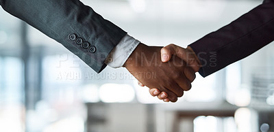 Buy stock photo Cropped shot of two unrecognizable businesspeople shaking hands in an office