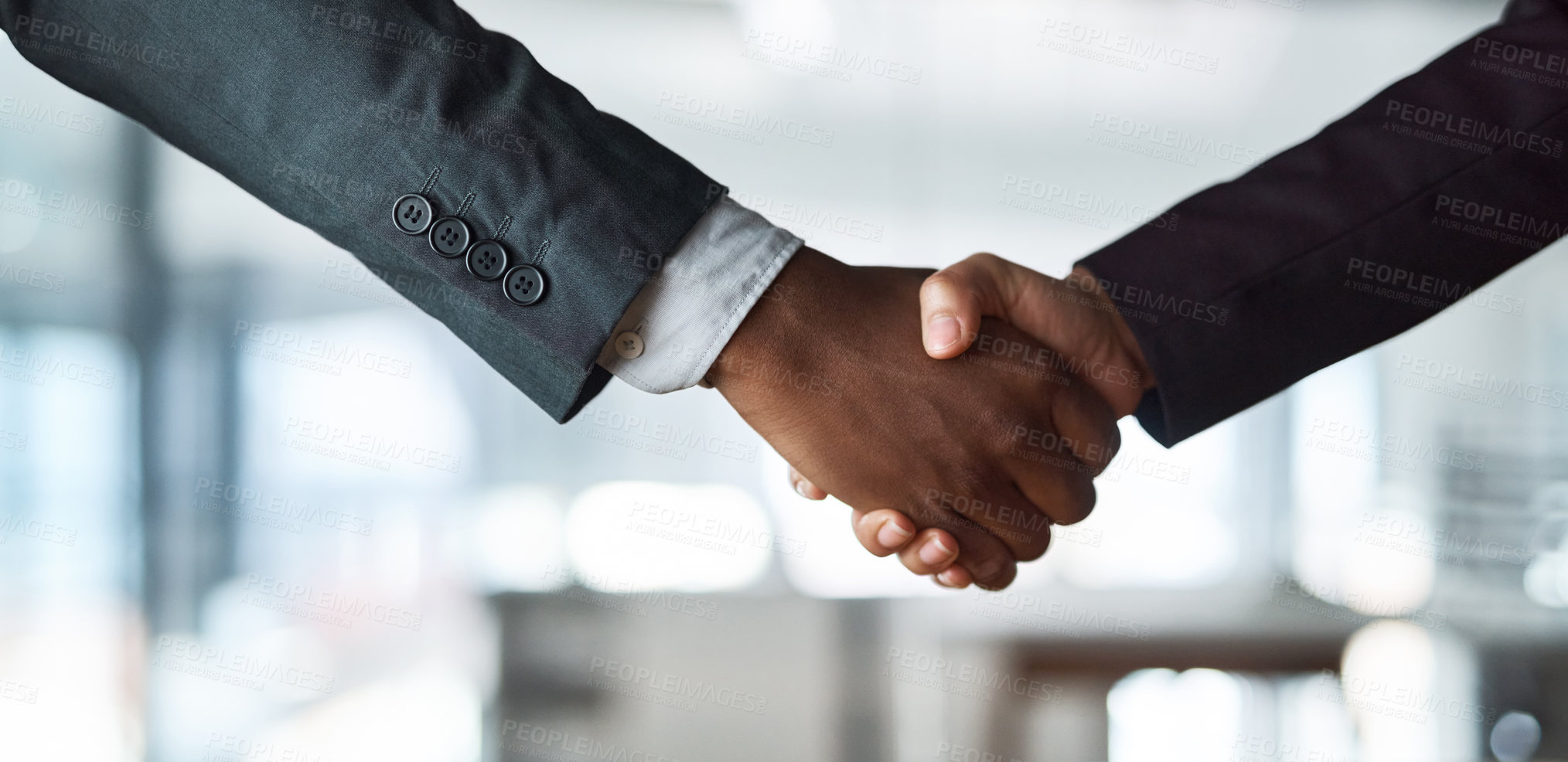 Buy stock photo Cropped shot of two unrecognizable businesspeople shaking hands in an office