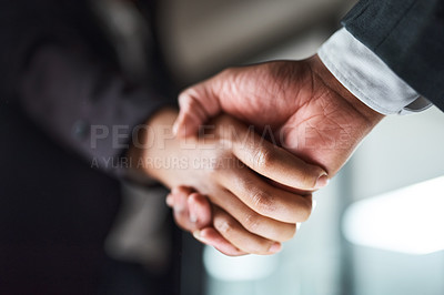 Buy stock photo Cropped shot of two unrecognizable businesspeople shaking hands in an office